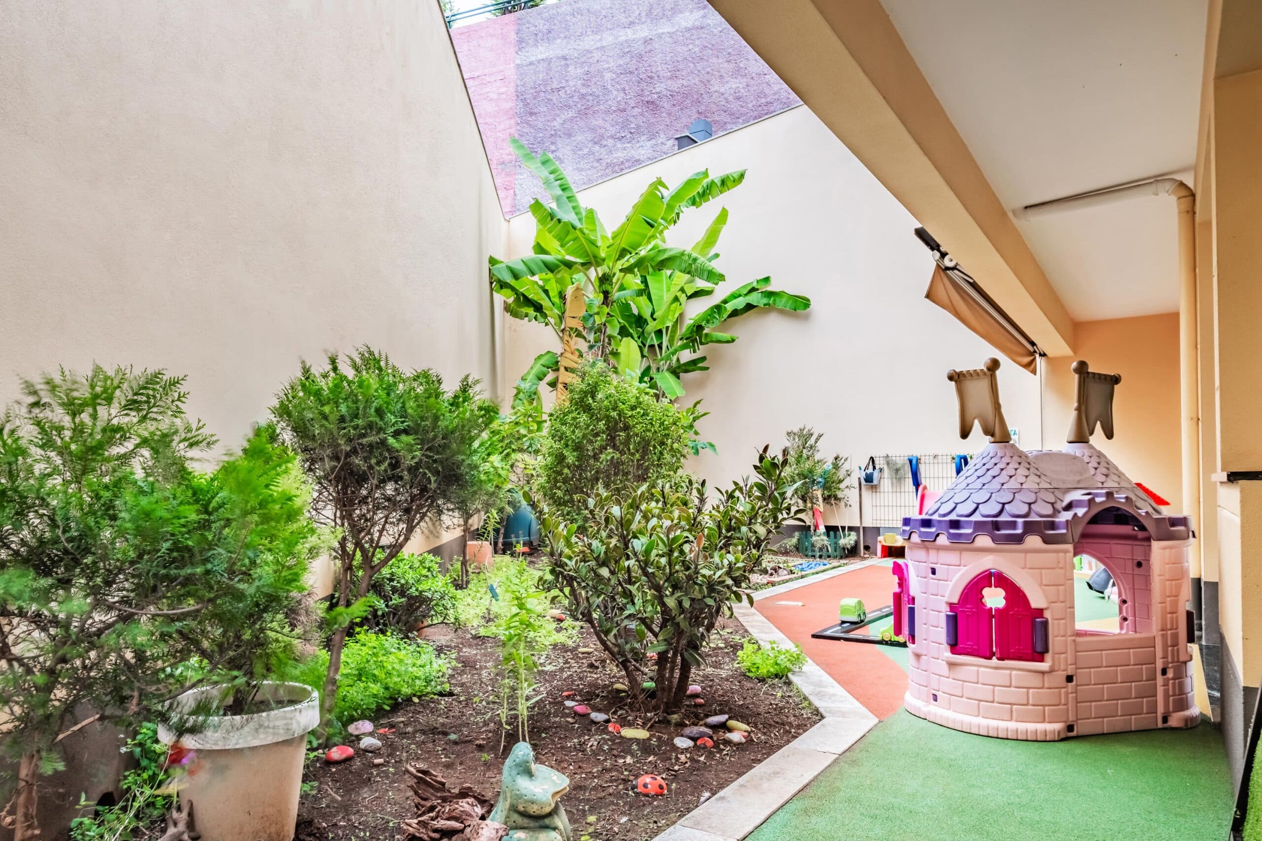 A horta com plantações, zona de texturas e bananeira do infantário A Toca dos Traquinas